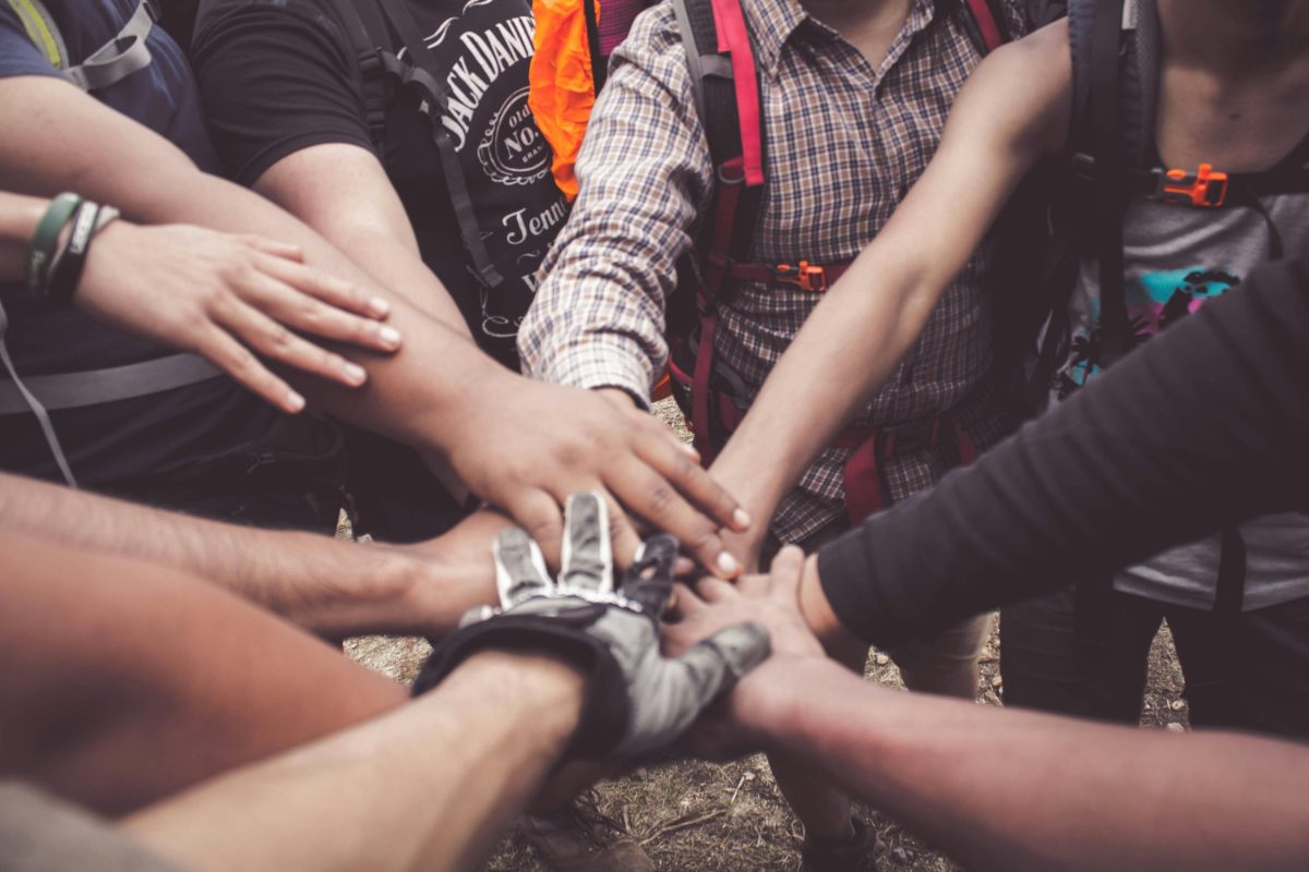 pexels-photo-3280130-3280130 A group of diverse individuals join hands for teamwork in West Java, Indonesia.